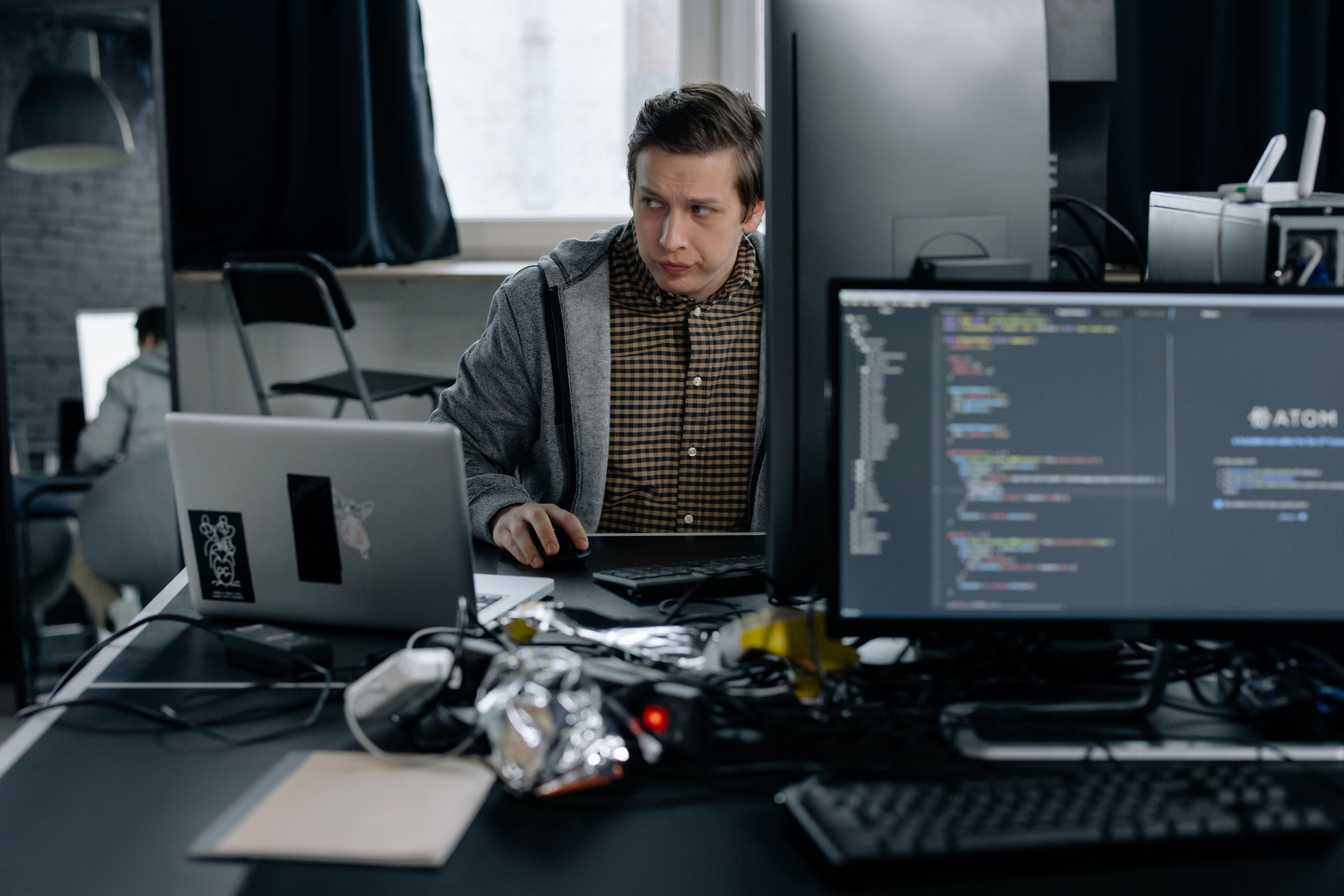 Developer integrating payments into software on a multi-screen setup