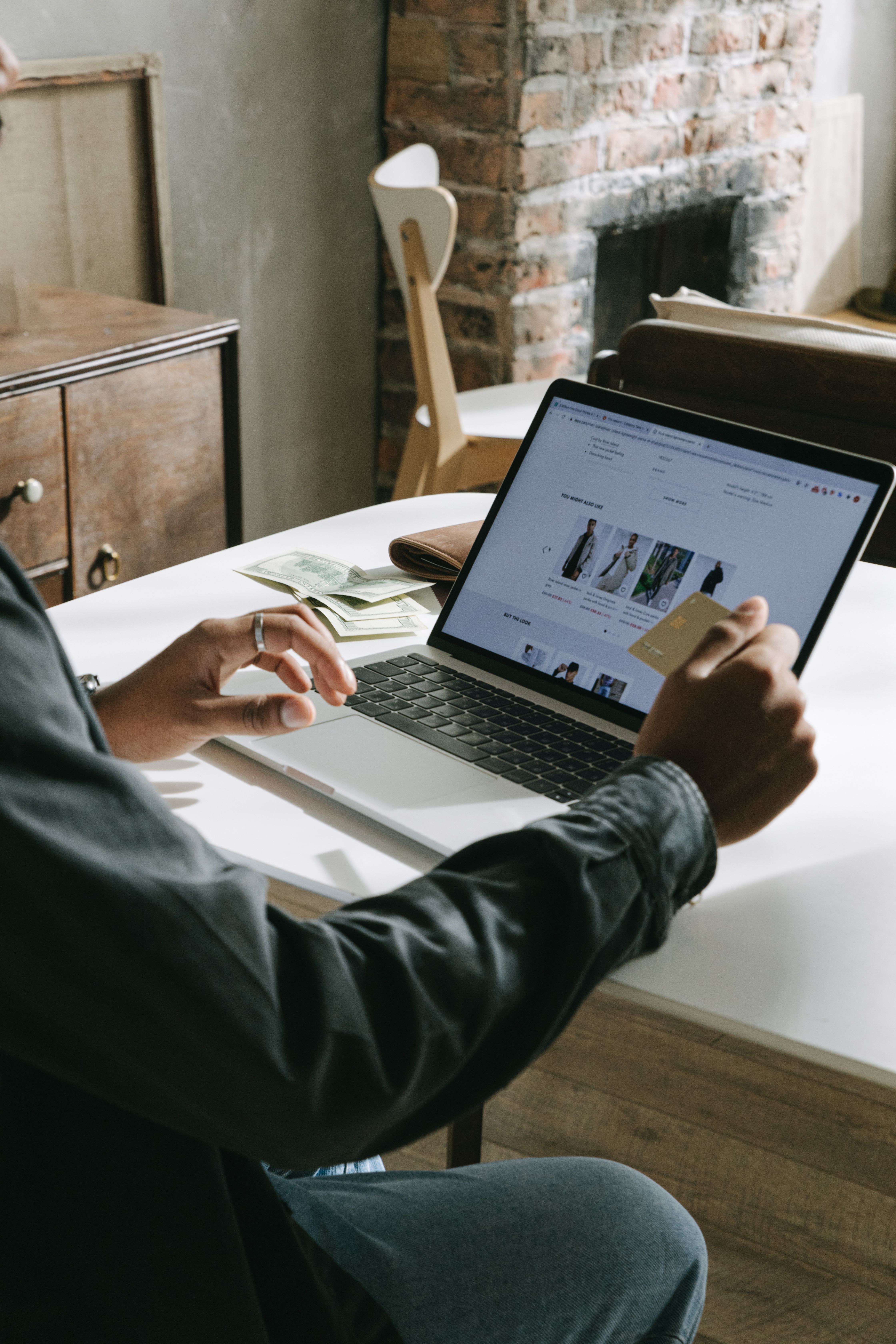 Customer checking out on an online store on a laptop with a card in hand
